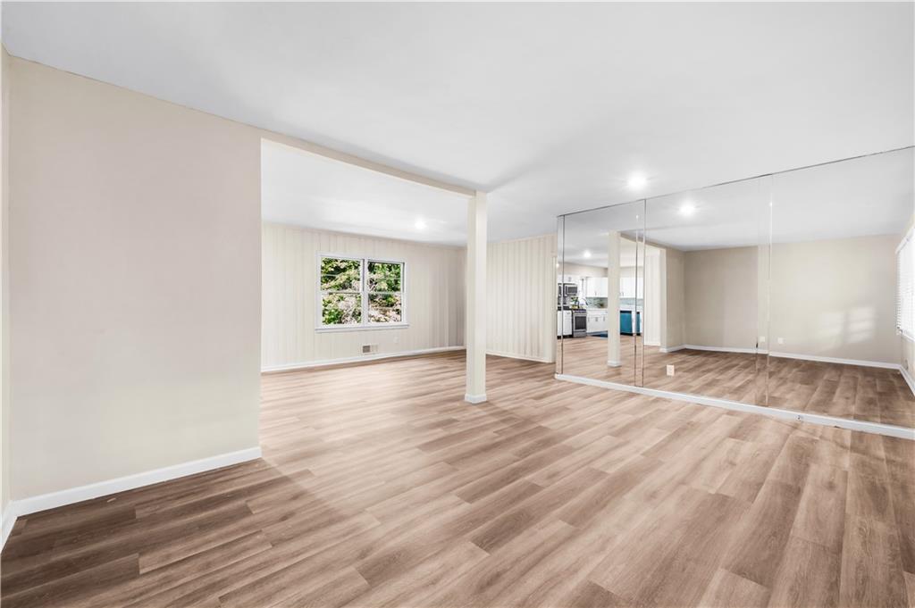 2773 Pasco Lane Southeast Atlanta, GA 30316 - Photo 4 of 40 an empty room with wooden floor and windows