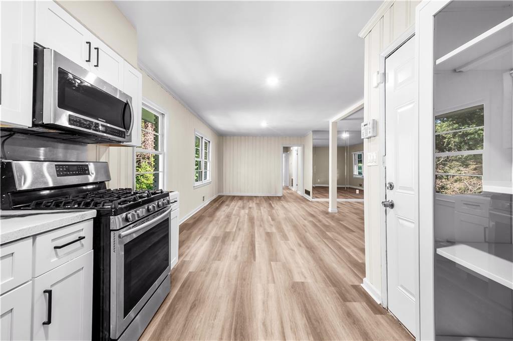 2773 Pasco Lane Southeast Atlanta, GA 30316 - Photo 7 of 40 a kitchen with stainless steel appliances a stove top oven a sink and a refrigerator