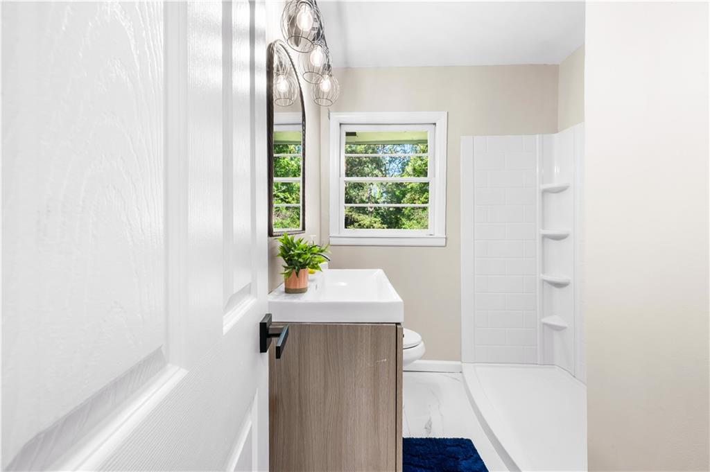 2773 Pasco Lane Southeast Atlanta, GA 30316 - Photo 10 of 40 a bath room with a sink and a bath tub
