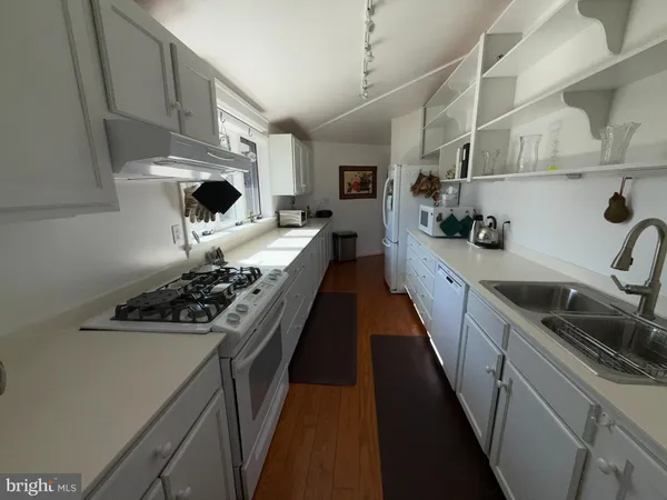 a kitchen with stainless steel appliances a sink stove and refrigerator