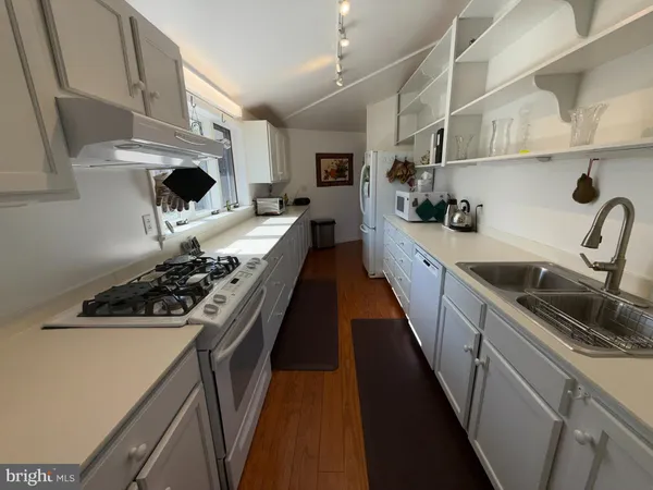 a kitchen with sink and cabinets