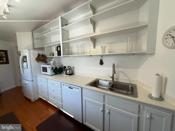 a large white kitchen with lots of appliances and cabinets