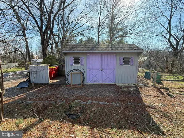 a view of a house with backyard and porch