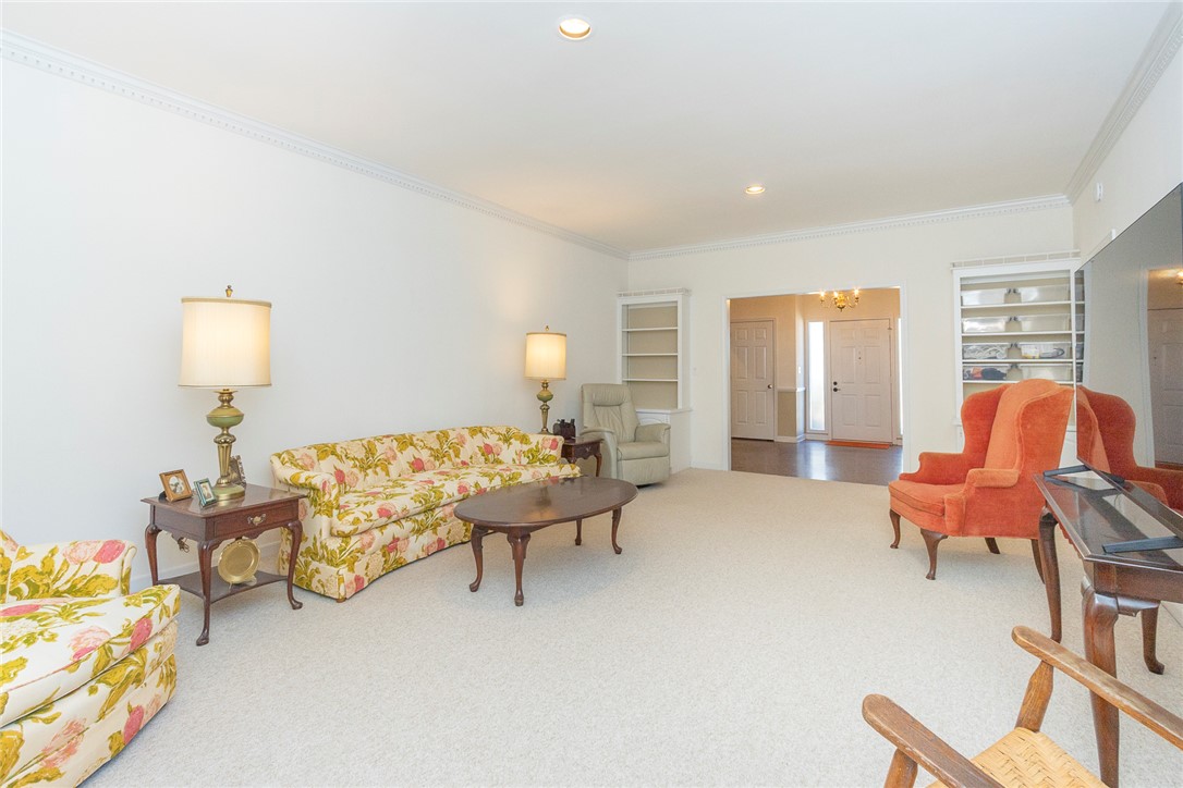 52 Hickory Way Clemson, SC 29631 - Photo 28 of 49 This bright living space features built-in shelving, crown molding, and plush carpeting.