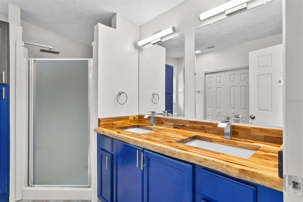 4793 Sunset Road St. Cloud, FL 34771 - Photo 12 of 28 a bathroom with a granite countertop sink and a mirror
