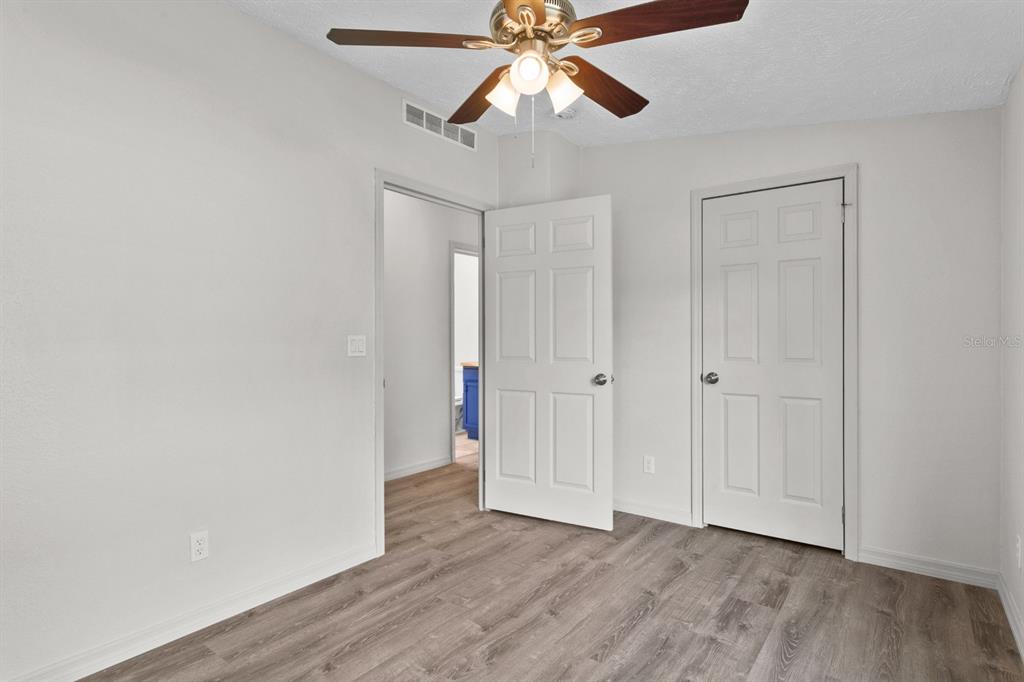 4793 Sunset Road St. Cloud, FL 34771 - Photo 15 of 28 a view of room with hardwood floor and ceiling fan