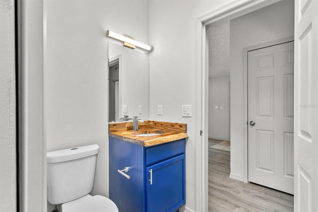 4793 Sunset Road St. Cloud, FL 34771 - Photo 18 of 28 a bathroom with a granite countertop sink and a mirror