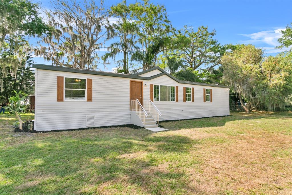 4793 Sunset Road St. Cloud, FL 34771 - Photo 2 of 28 a view of a house with a yard