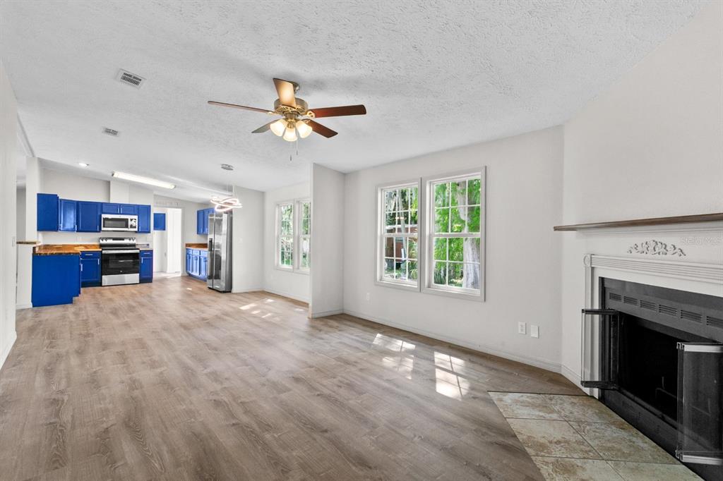 4793 Sunset Road St. Cloud, FL 34771 - Photo 3 of 28 a view of an empty room with a fireplace and a window