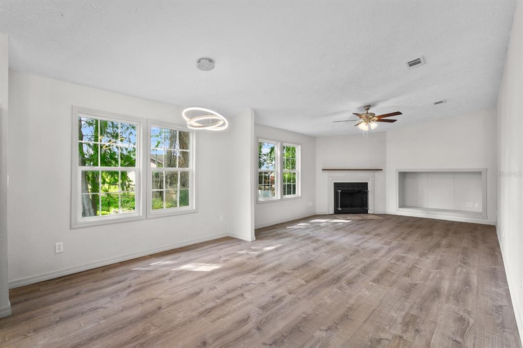 4793 Sunset Road St. Cloud, FL 34771 - Photo 4 of 28 an empty room with windows and fireplace