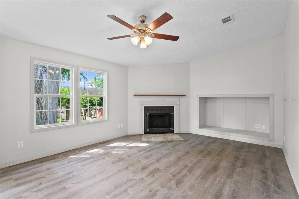 4793 Sunset Road St. Cloud, FL 34771 - Photo 5 of 28 an empty room with windows and fireplace