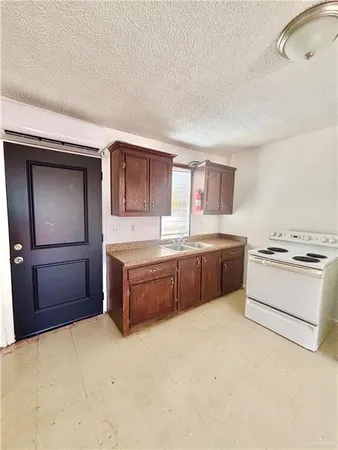 a large kitchen with a large counter top space and stainless steel appliances