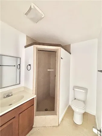 a bathroom with a toilet sink and shower
