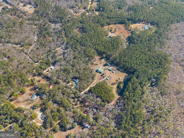 a front view of a house with a yard covered in snow