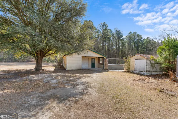 a view of a house with a yard and garage