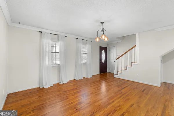 a view of an empty room with window and cabinet