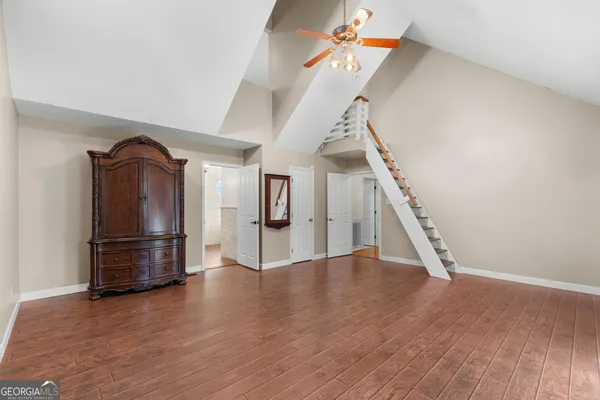 a view of a room with a ceiling fan and a chandelier fan
