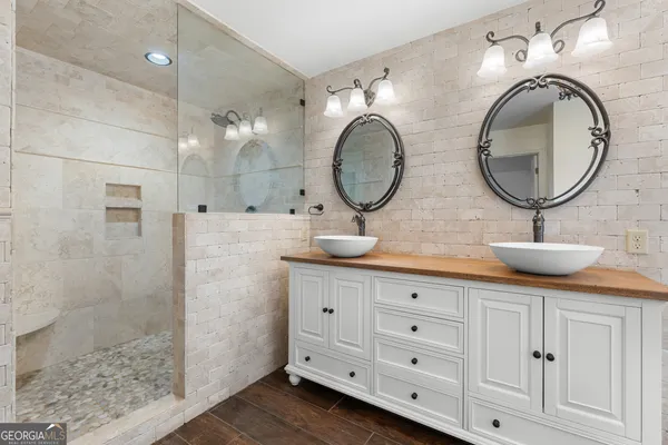 a bathroom with a bathtub and a shower