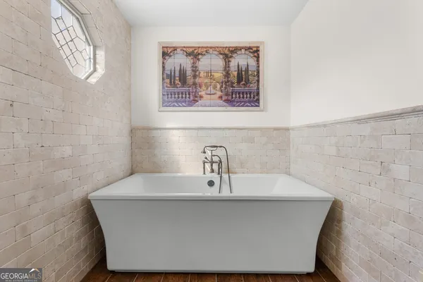 a spacious bedroom with a bed and a dresser