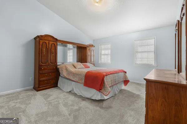 a view of empty room with closet and windows