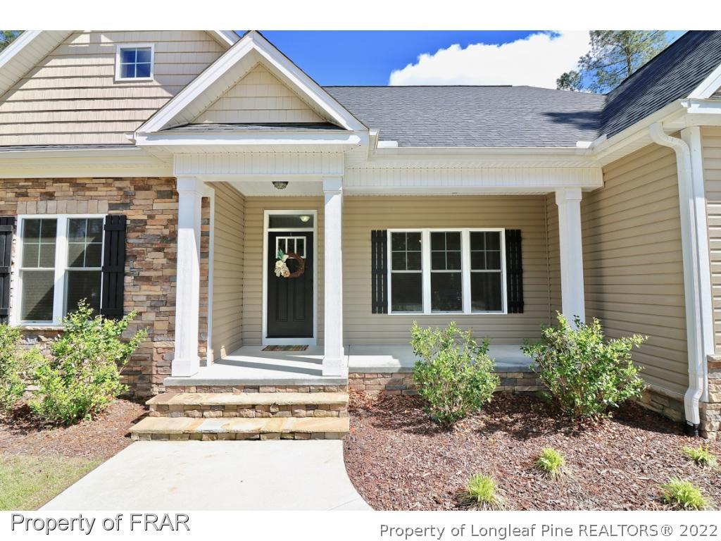 1187 Rays Bridge Road Whispering Pines, NC 28327 - Photo 11 of 35 a house view with a outdoor space