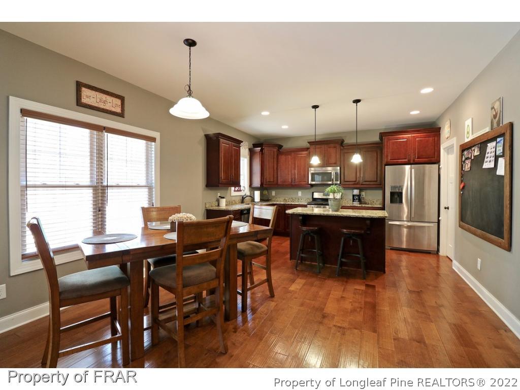 1187 Rays Bridge Road Whispering Pines, NC 28327 - Photo 13 of 35 a open kitchen with a table and chairs