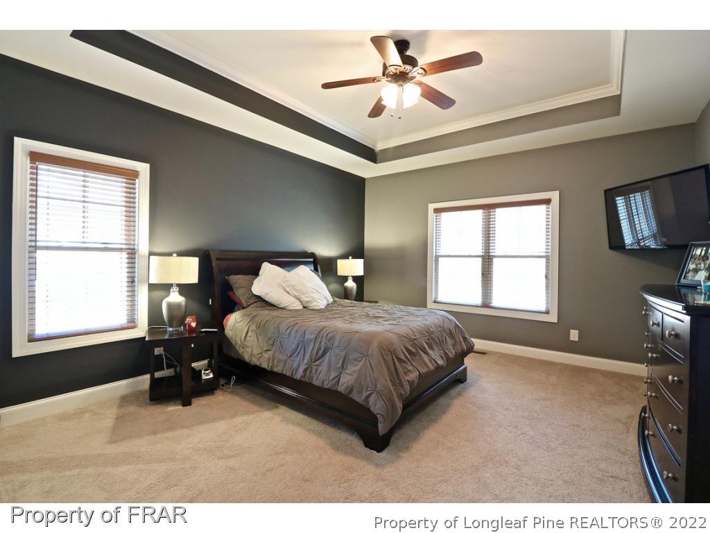 1187 Rays Bridge Road Whispering Pines, NC 28327 - Photo 15 of 35 a bedroom with a bed mirror on table and a window
