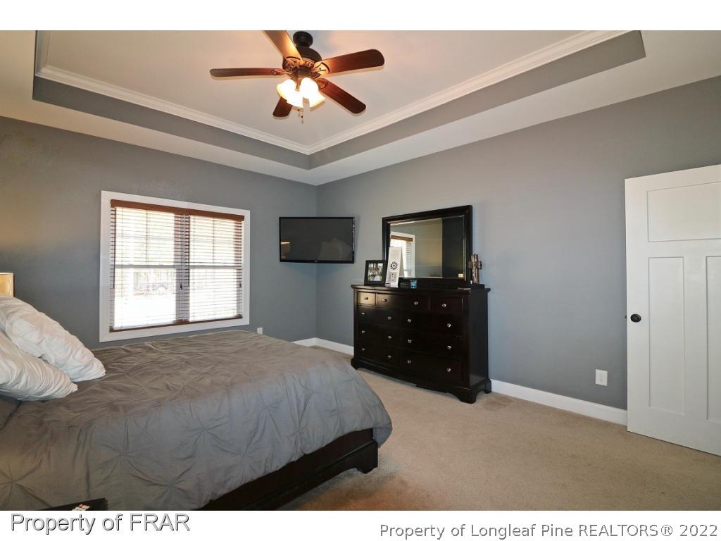 1187 Rays Bridge Road Whispering Pines, NC 28327 - Photo 17 of 35 a bedroom with a bed dresser and a window