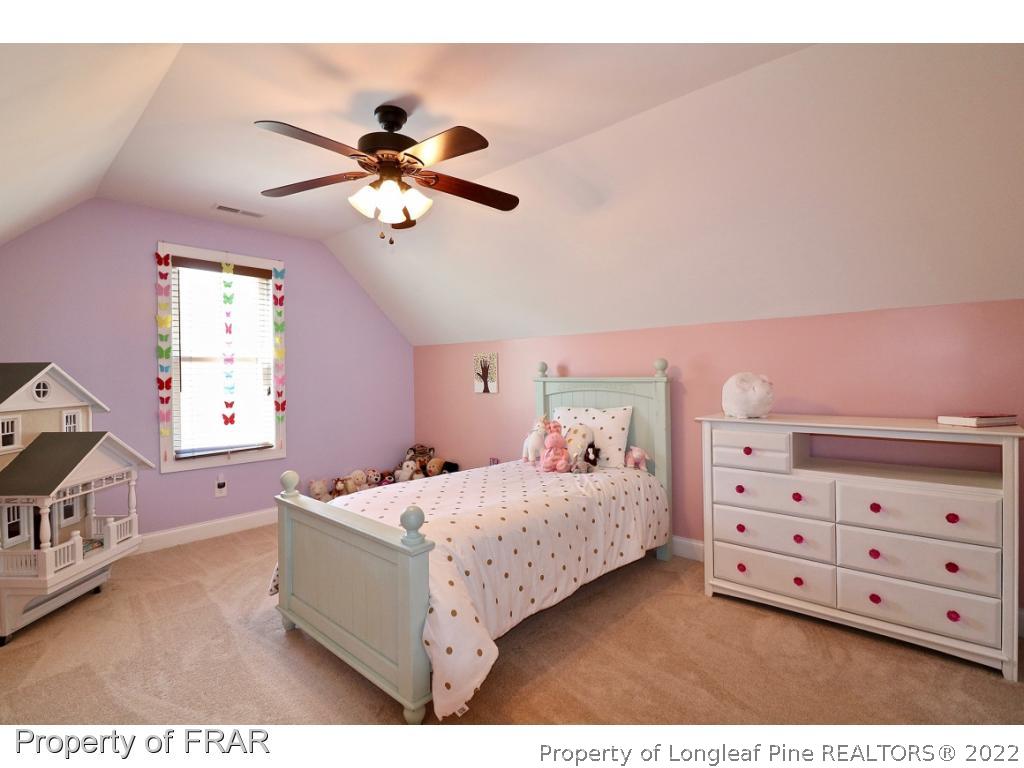 1187 Rays Bridge Road Whispering Pines, NC 28327 - Photo 23 of 35 a bedroom with a bed and a dresser