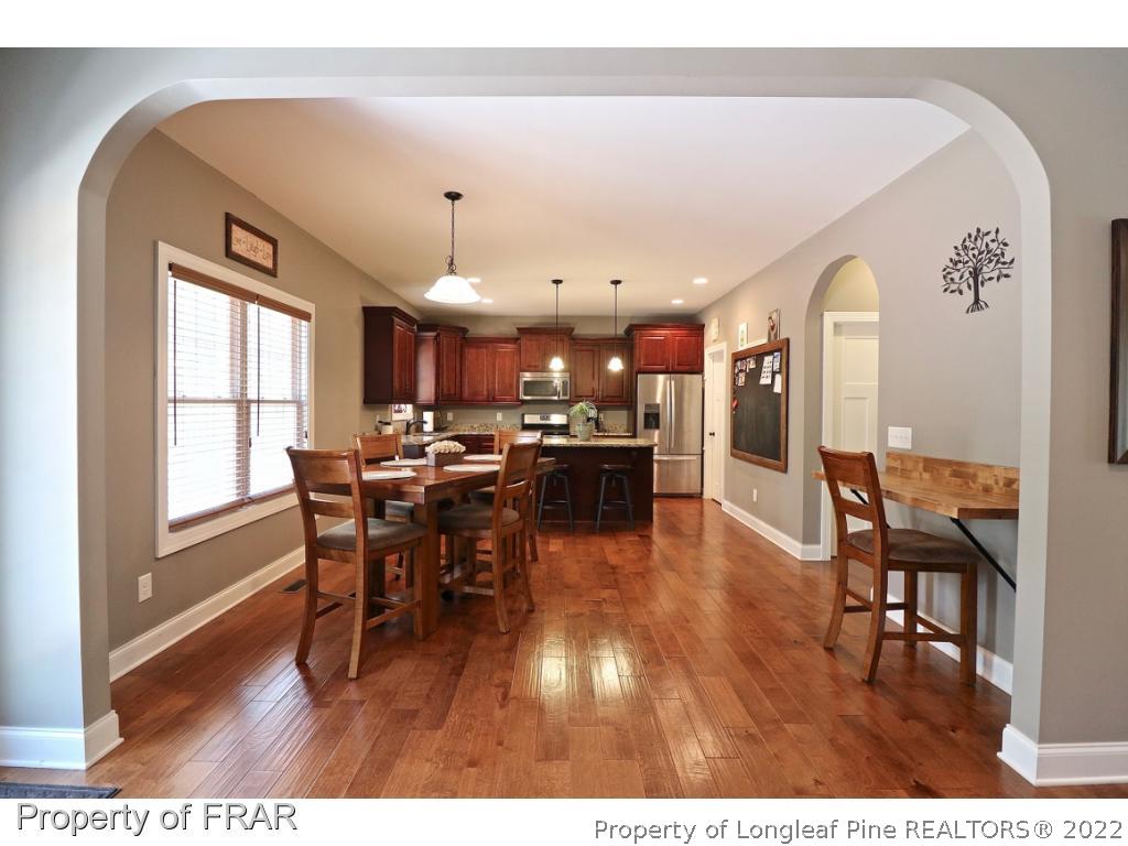 1187 Rays Bridge Road Whispering Pines, NC 28327 - Photo 31 of 35 a dining room with furniture and wooden floor