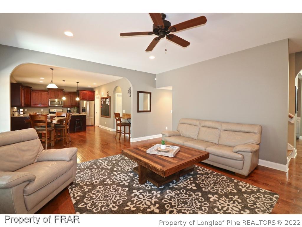 1187 Rays Bridge Road Whispering Pines, NC 28327 - Photo 6 of 35 a living room with furniture and kitchen view
