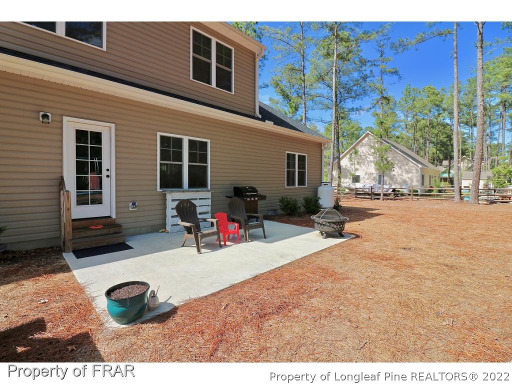 1187 Rays Bridge Road Whispering Pines, NC 28327 - Photo 9 of 35 a view of a house with backyard and sitting area