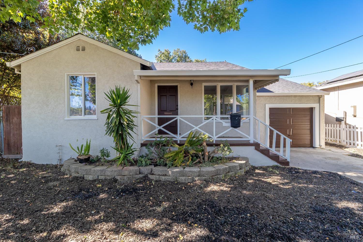 a view of a house with backyard and sitting area