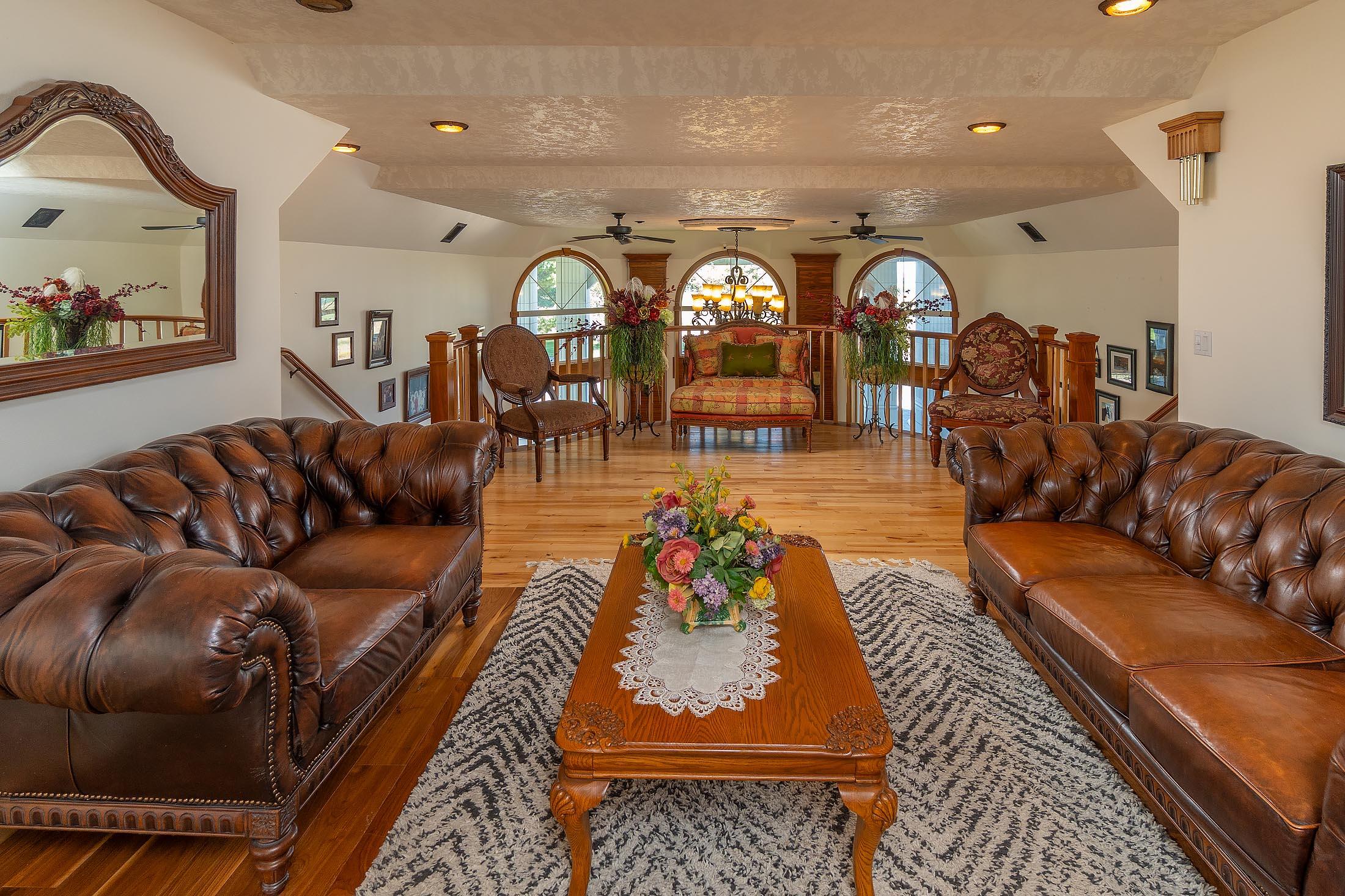 59047 Old Lake Road Christmas Valley, OR 97641 - Photo 12 of 55 Upstairs balcony formal living room with inlaid wood flooring