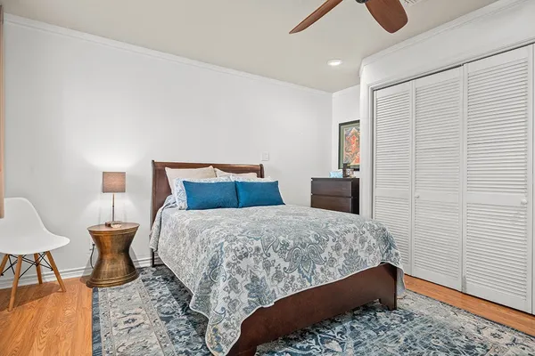 a bedroom with a bed and a lamp on desk