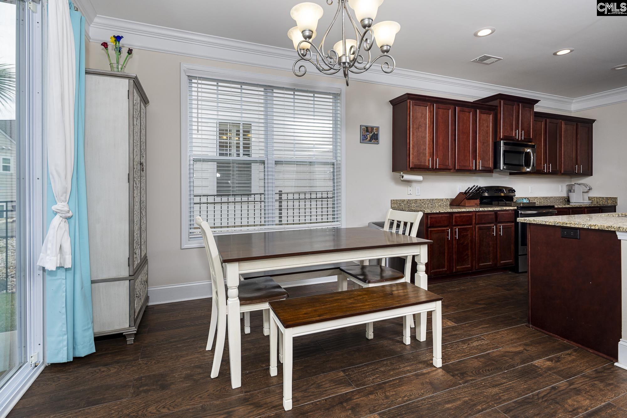 213 Sunset Point Drive Lexington, SC 29072 - Photo 15 of 35 a kitchen with a table chairs and refrigerator