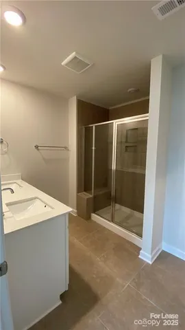 a bathroom with a shower and sink