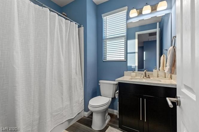 805 East Sunset Road Henderson, NV 89011 - Photo 20 of 43 Full bathroom featuring vanity, wood finished floors, and a shower with shower curtain