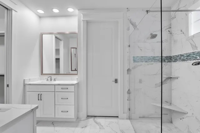 a bathroom with a double vanity sink and mirror