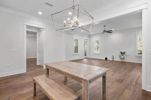 a living room with kitchen island furniture and wooden floor