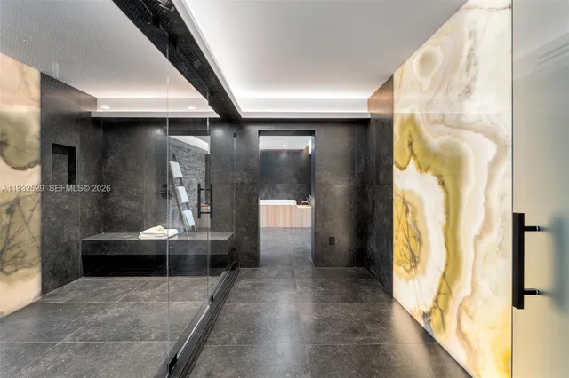 a view of a hallway with wooden floor and a living room