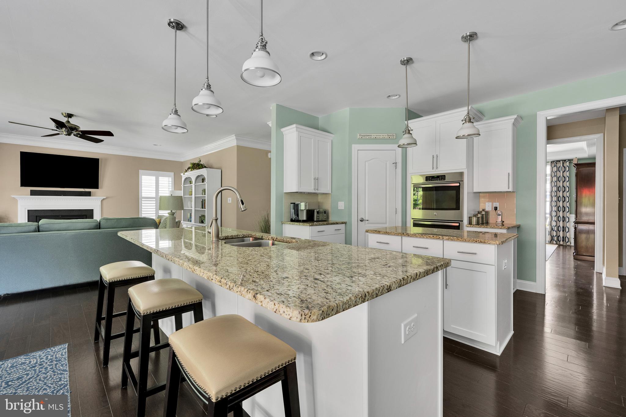 18131 Emerson Way Georgetown, DE 19947 - Photo 15 of 52 a kitchen with stainless steel appliances granite countertop a kitchen island a stove and a sink