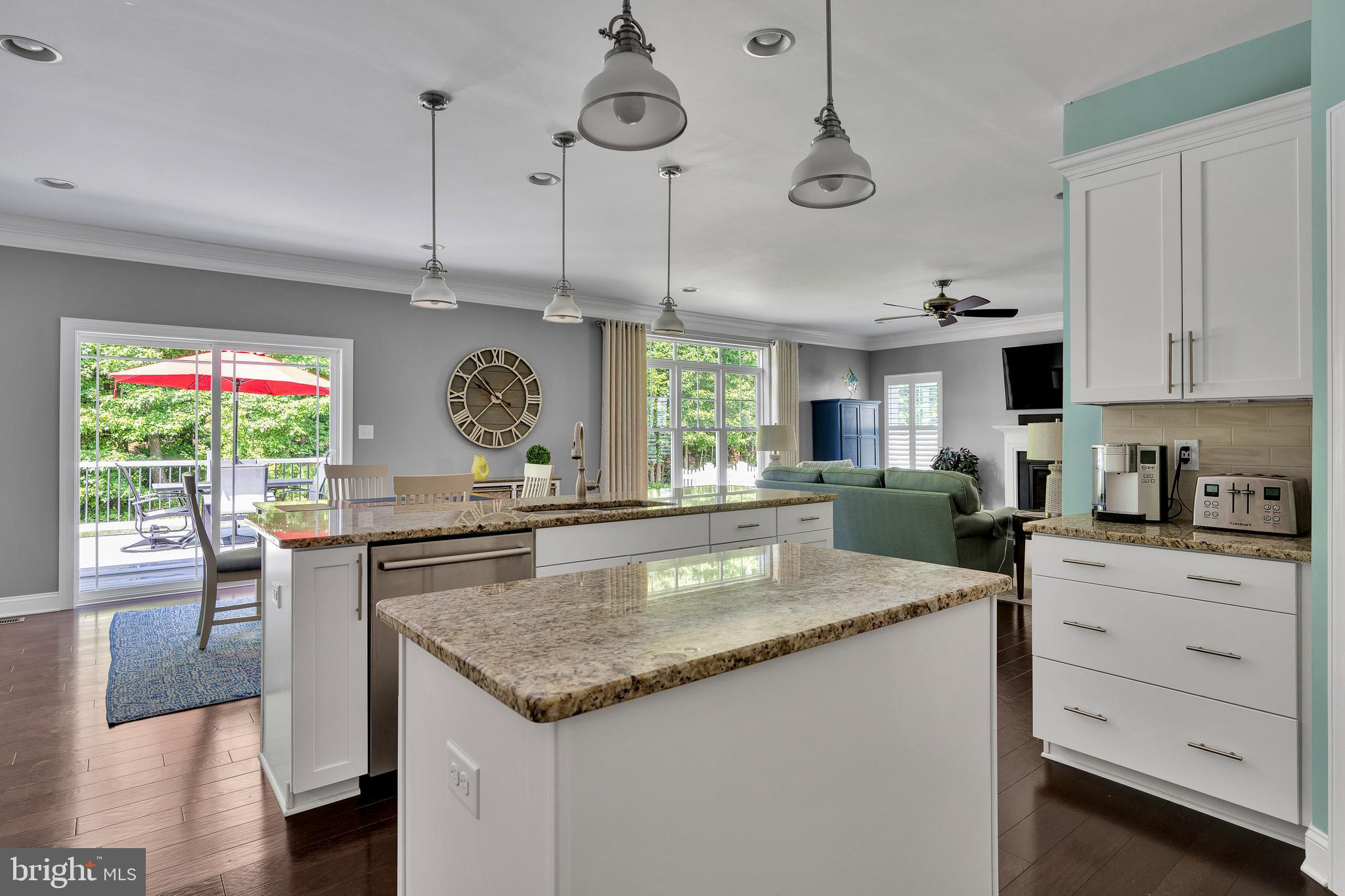 18131 Emerson Way Georgetown, DE 19947 - Photo 16 of 52 a kitchen with stainless steel appliances granite countertop a sink a stove and a wooden floors
