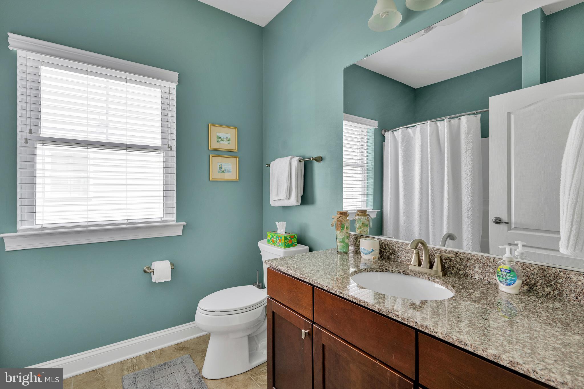 18131 Emerson Way Georgetown, DE 19947 - Photo 27 of 52 a bathroom with a granite countertop sink toilet and mirror