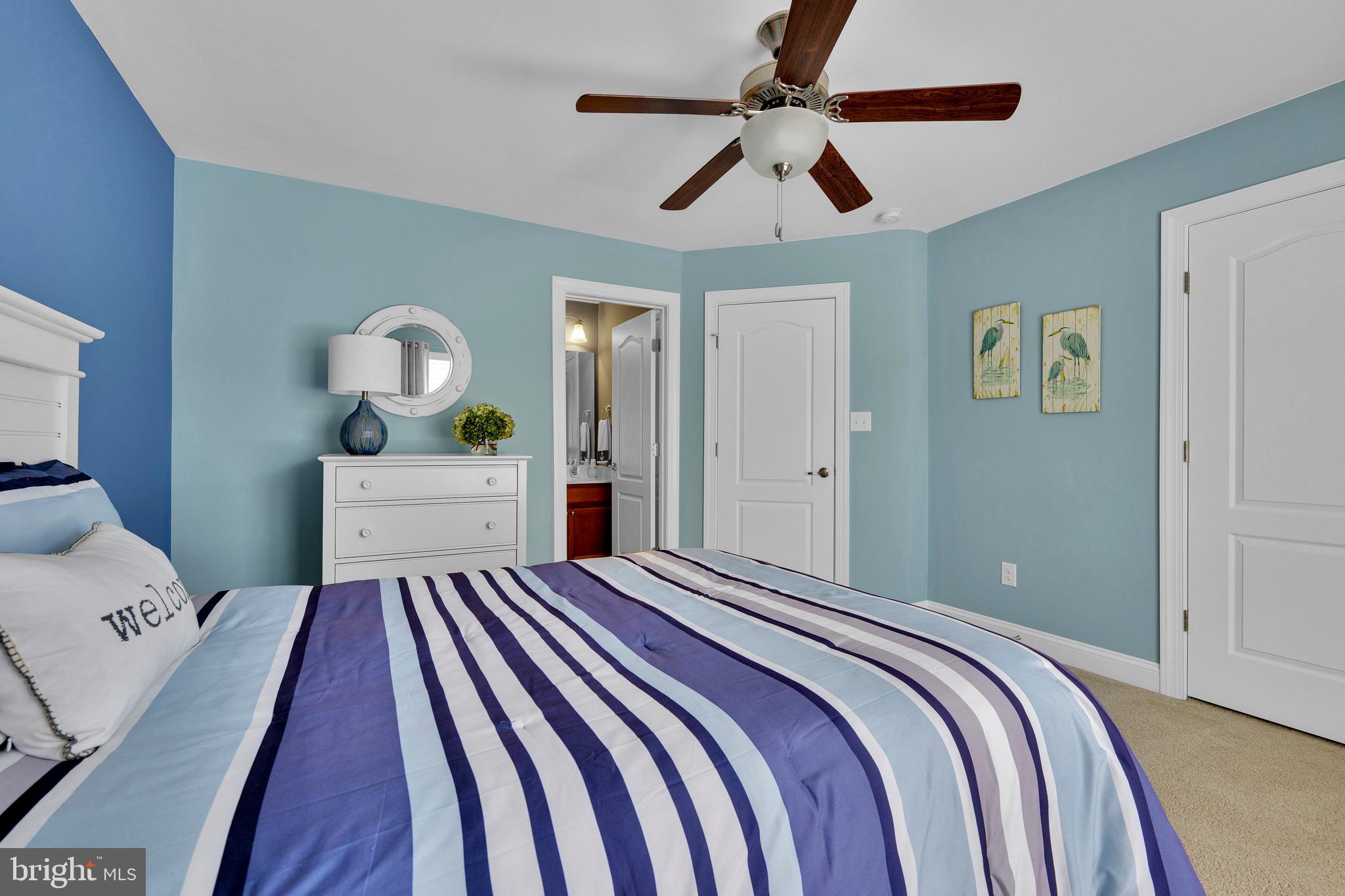 18131 Emerson Way Georgetown, DE 19947 - Photo 33 of 52 a bedroom with a bed and a chandelier