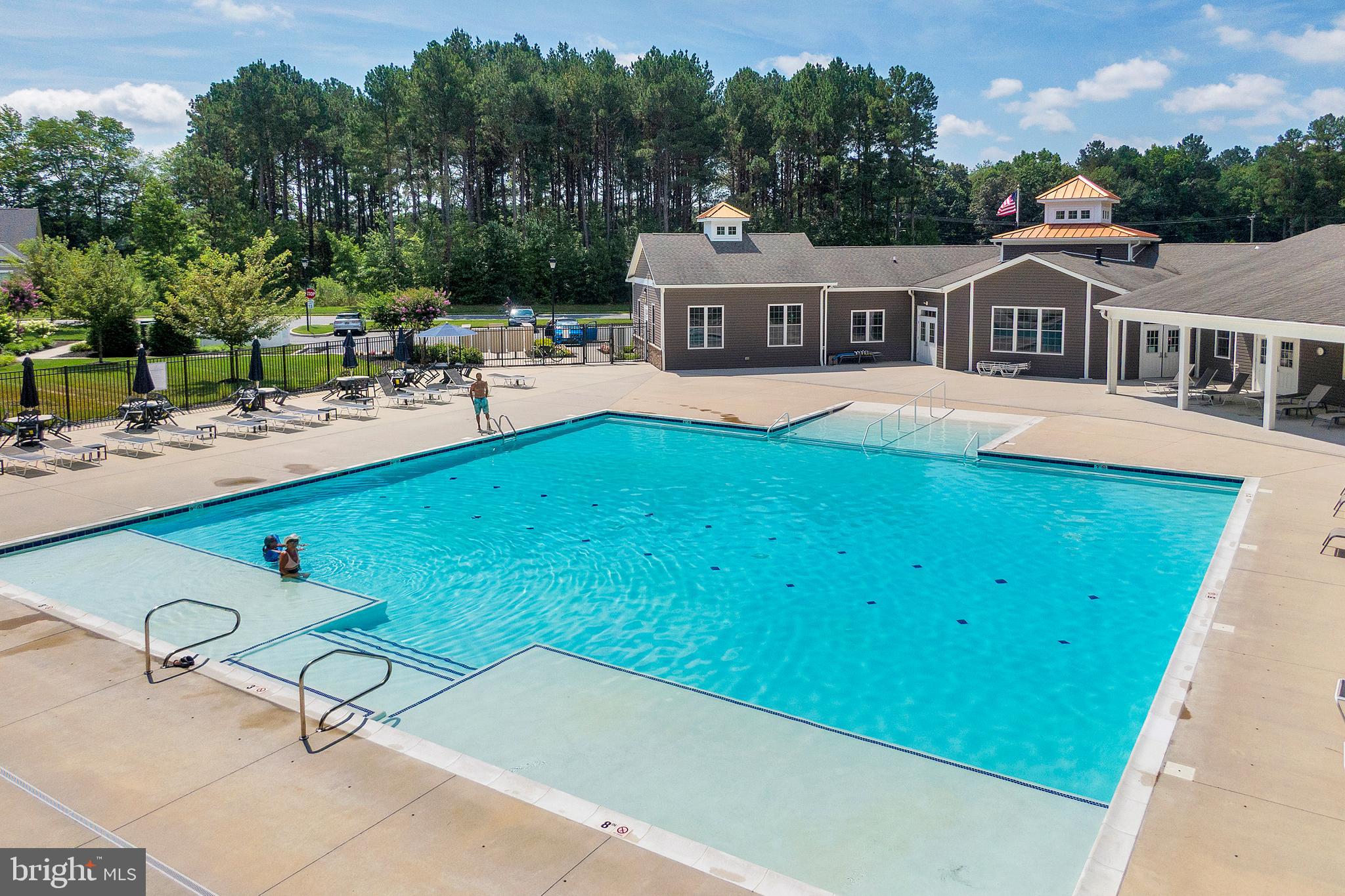 18131 Emerson Way Georgetown, DE 19947 - Photo 48 of 52 a view of a house with pool and chairs