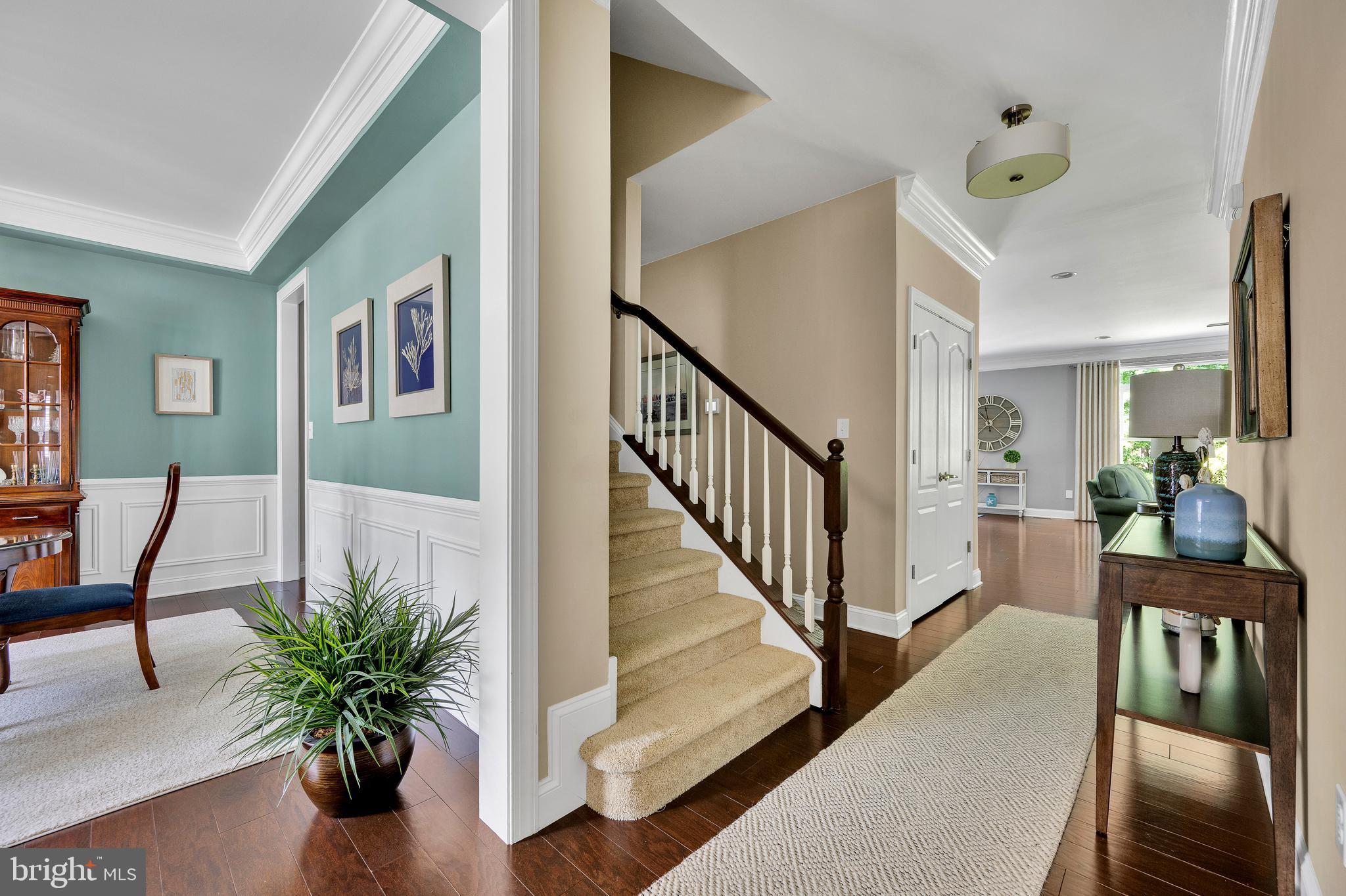 18131 Emerson Way Georgetown, DE 19947 - Photo 7 of 52 a view of a hallway with wooden floor and furniture