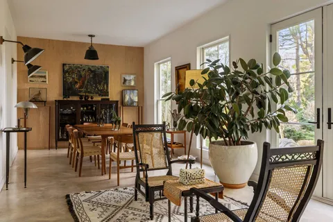 a view of a dining room with furniture and window