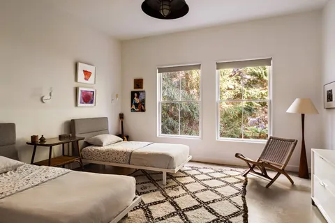 a bedroom with two beds and a window