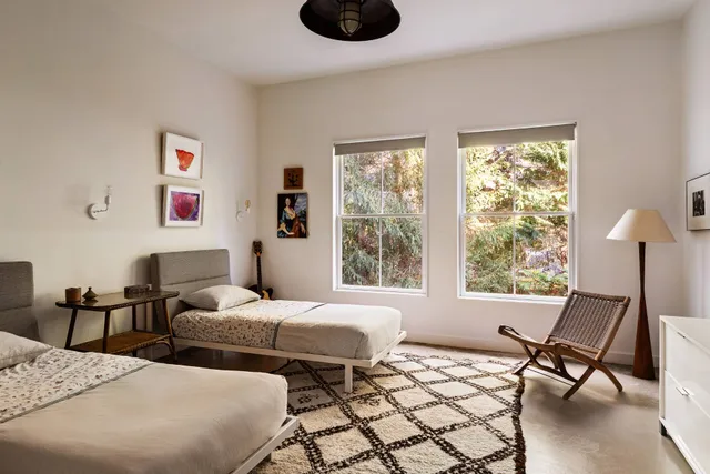 a bedroom with two beds and a window